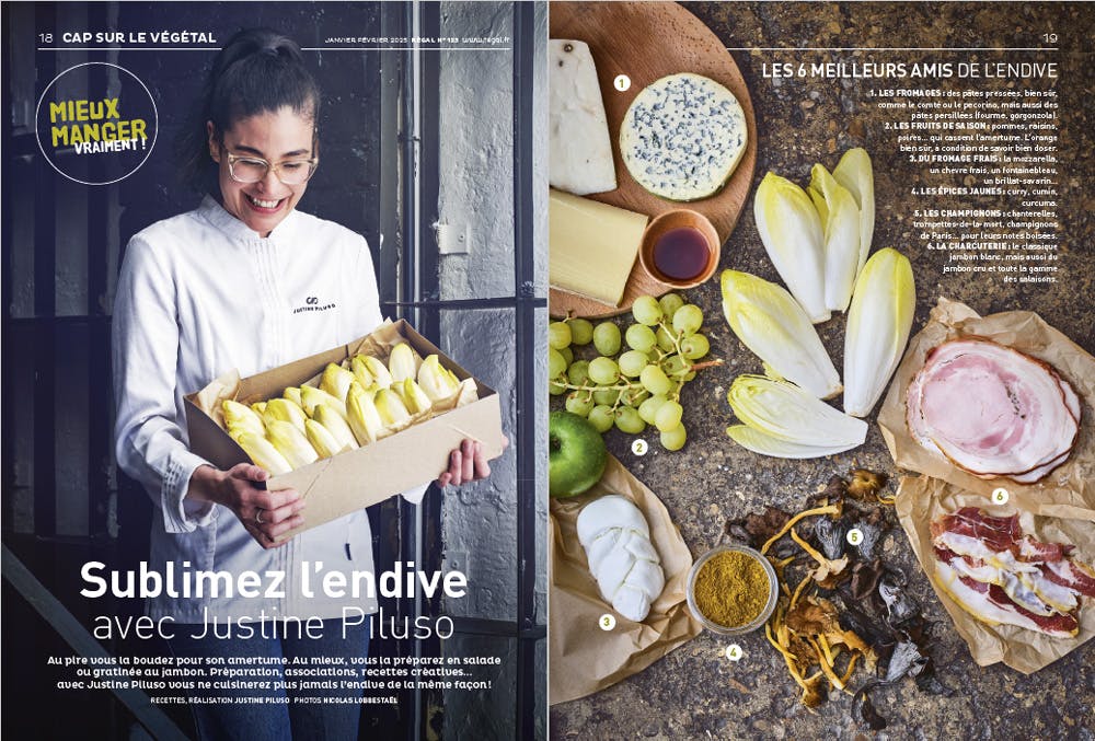 Chef tenant une caisse d'endives à côté d'ingrédients sur une table.